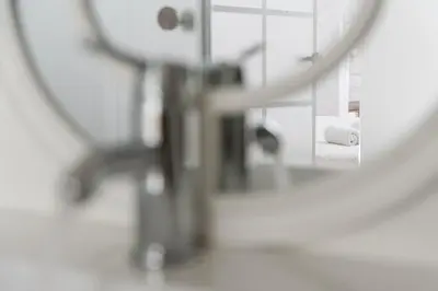 a mirror in a bathroom with a bed and a sink at GuestReady - Bright Apartment near Bolhão in Porto