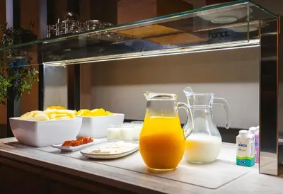 a counter with a drink and a plate of food at Acta The Clover in Porto