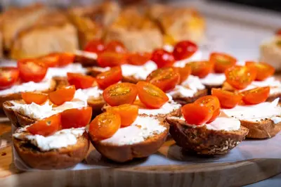 a tray of bread with cheese and fruit on it at Acta The Clover in Porto