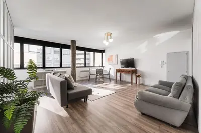 a living room with two couches and a television at GuestReady - Grayscale in Porto
