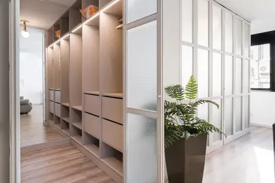 a room with a wall of shelves and a plant at GuestReady - Grayscale in Porto