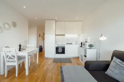a living room with a table and a kitchen at Downtown Stylish Apartment With Garage by Vacationy in Porto