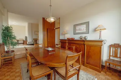 a dining room with a wooden table and chairs at Grand Botanic Garden Apartment by Vacationy in Porto