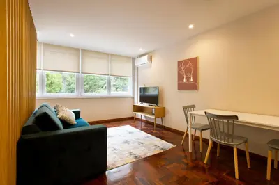 a living room with a couch and a table at Aposentus - Your home in Porto in Porto