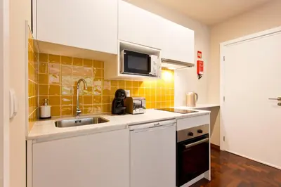 a kitchen with a sink and a microwave at Aposentus - Your home in Porto in Porto