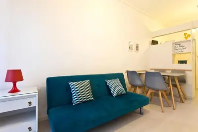 a living room with a green couch and chairs at Aposentus - Breiner Apartment in Porto