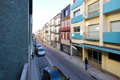 a city street with cars parked next to buildings at Aposentus - Breiner Apartment in Porto