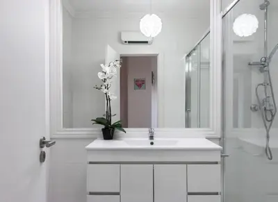 a white bathroom with a sink and a mirror at HEART OF THE CITY 2! in Vila Nova de Gaia