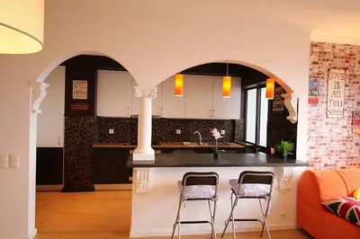 a dining room with a table and a brick wall at HEART OF THE CITY 2! in Vila Nova de Gaia