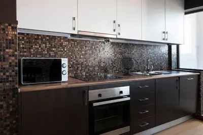a kitchen with white cabinets and a microwave at HEART OF THE CITY 2! in Vila Nova de Gaia