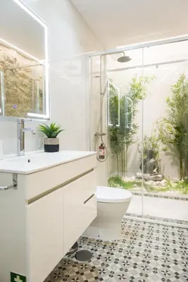 a bathroom with a sink and a toilet and a window at Casa Barros - Trindade in Porto