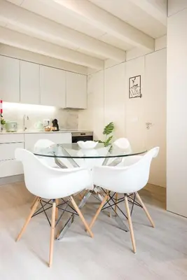 a dining room with a glass table and white chairs at Casa Barros - Miragaia in Porto