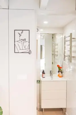 a white bathroom with a sink and a mirror at Casa Barros - Miragaia in Porto