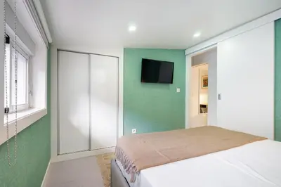 a bedroom with a bed and a flat screen tv at WHome Porto City Center Comfort & Stylishly Furnished in Porto