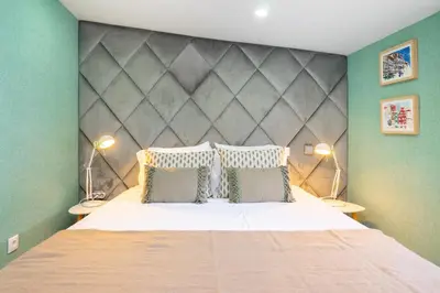 a bedroom with a large bed with two lamps at WHome Porto City Center Comfort & Stylishly Furnished in Porto