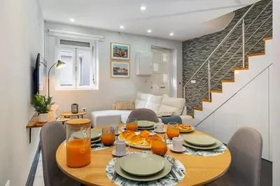 a dining room with a table with oranges on it at WHome Porto City Center Comfort & Stylishly Furnished in Porto