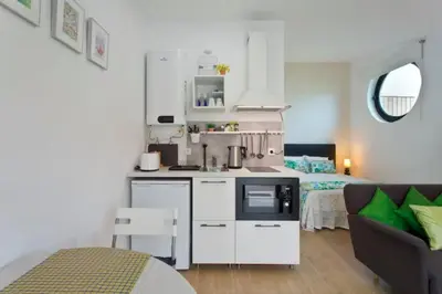 a kitchen and a living room with a bed at Urban Cabin in Vila Nova de Gaia