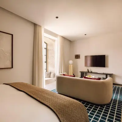 a hotel room with a couch and a television at The Rebello Hotel & Spa - Small Luxury Hotels Of The World in Vila Nova de Gaia