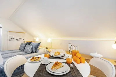 a living room with a table with food on it at Douro Prestige Urban Retreat with shared S-Pool & Gym in Porto