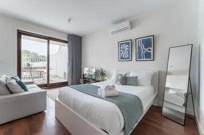 a bedroom with a large bed and a mirror at GuestReady - Almada 516 in Porto