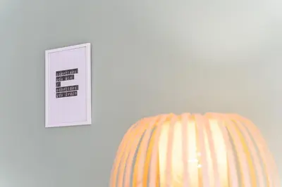 a lightswitch next to a white wall with a striped pillow at GuestReady - Almada 516 in Porto