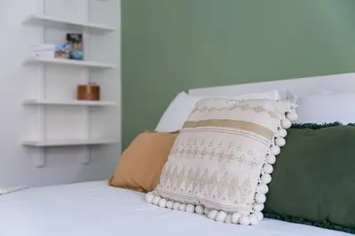 a white pillow sitting on top of a bed at GuestReady - Almada 516 in Porto