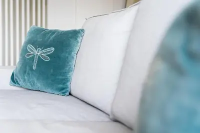 a blue pillow sitting on top of a bed at GuestReady - Almada 516 in Porto