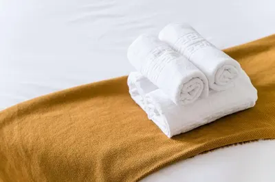a stack of rolled towels on a brown towel at GuestReady - Almada 516 in Porto