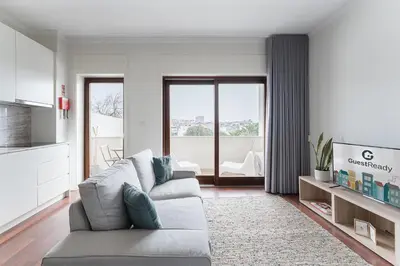 a living room with a couch and a tv at GuestReady - Almada 516 in Porto