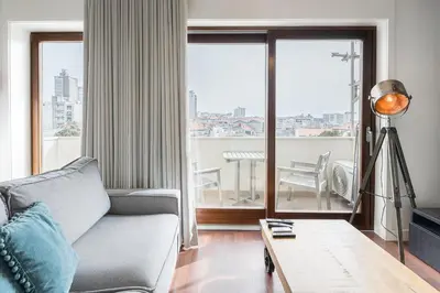 a living room with a couch and a large window at GuestReady - Almada 516 in Porto