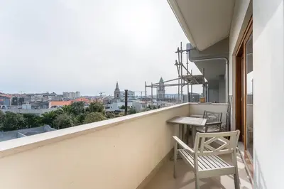 a balcony with two chairs and a table and a view at GuestReady - Almada 516 in Porto