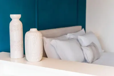 three white vases are sitting on a shelf at GuestReady - Almada 516 in Porto
