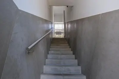 a staircase in a building with a concrete wall at GuestReady - Port Studio 4 in Vila Nova de Gaia