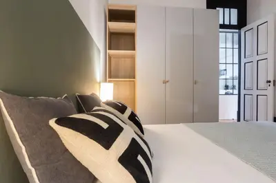 a bedroom with a bed with a pillow on it at Amazing Family Flat in Center Porto in Porto