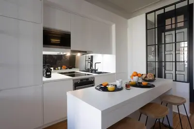 a kitchen with white cabinets and a white counter top at Amazing Family Flat in Center Porto in Porto