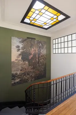 a large painting on the wall with a glass ceiling at Amazing Family Flat in Center Porto in Porto