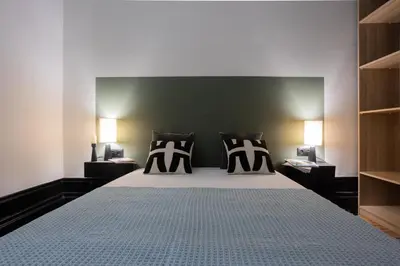 a bedroom with a bed with two lamps on it at Amazing Family Flat in Center Porto in Porto