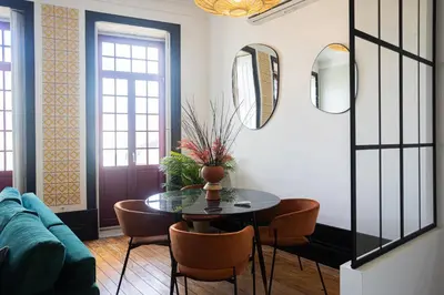 a living room with a table and chairs and a couch at Amazing Family Flat in Center Porto in Porto