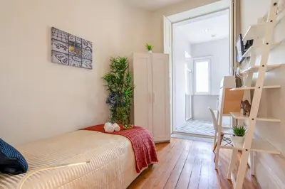 a bedroom with a bed and a ladder in a room at Host Wise - Sweet Bright Flats - City Center in Porto