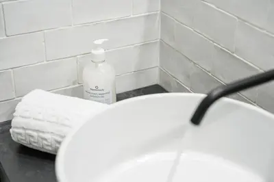 a bathroom with a white sink and a bottle of soap at GuestReady - Cosy in the Historic Heart of Porto in Porto