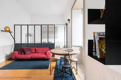 a living room with a red couch and a table at GuestReady - Cosy in the Historic Heart of Porto in Porto