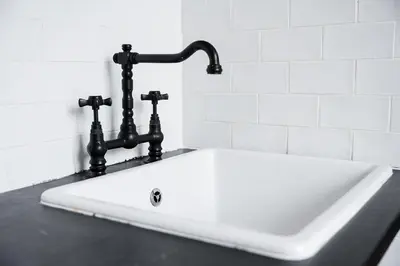 a white sink with a black faucet on a counter at GuestReady - Cosy in the Historic Heart of Porto in Porto