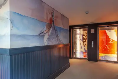 a room with a painting of a ship on the wall at Timbre Virtudes in Porto