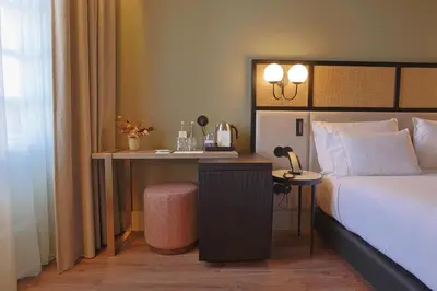 a hotel room with a bed and a desk at Timbre Virtudes in Porto