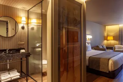 a hotel room with a bed and a bathroom at Timbre Virtudes in Porto