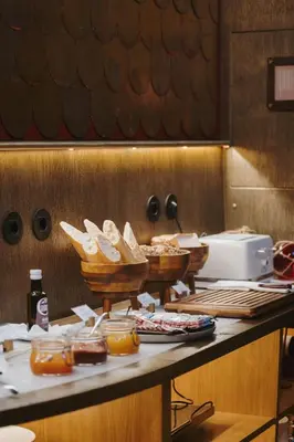 a counter with baskets of bread and other food on it at Timbre Virtudes in Porto