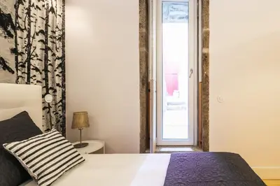 a bedroom with a bed and a window at Charming T2 by Indulge Porto Flats in Porto