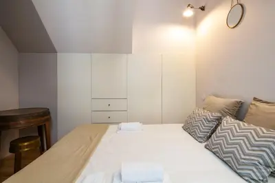 a bedroom with a large white bed with two pillows at Charming T2 by Indulge Porto Flats in Porto