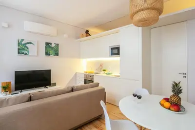 a living room with a couch and a table at Charming T2 by Indulge Porto Flats in Porto