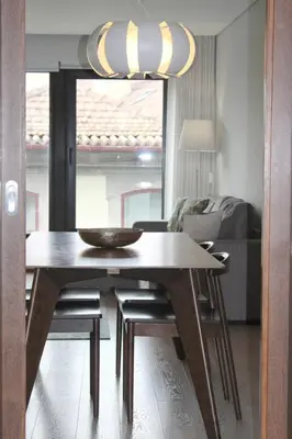 a kitchen with a table and a dining room at Casa do Teatro Oporto Downtown in Porto